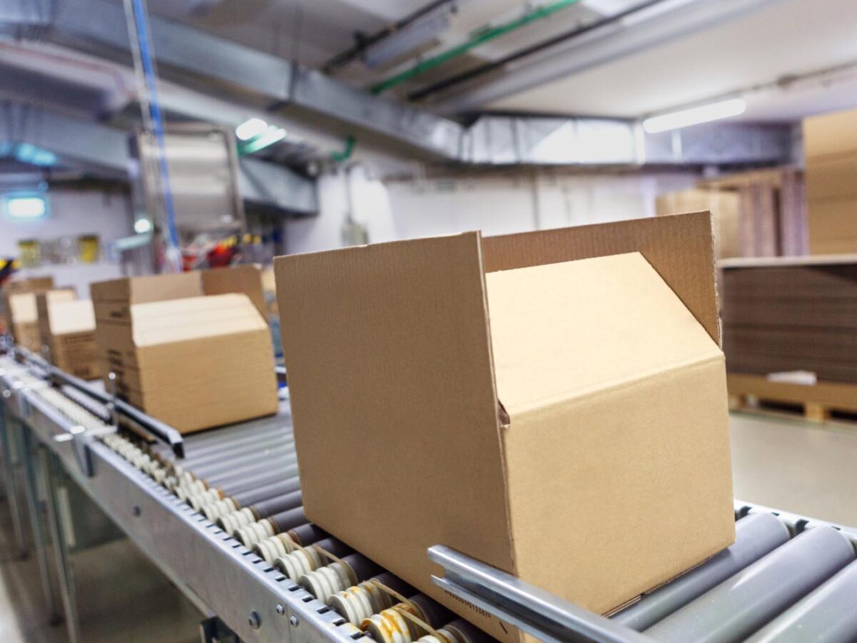 Cardboard packaging on a conveyor belt in logistics